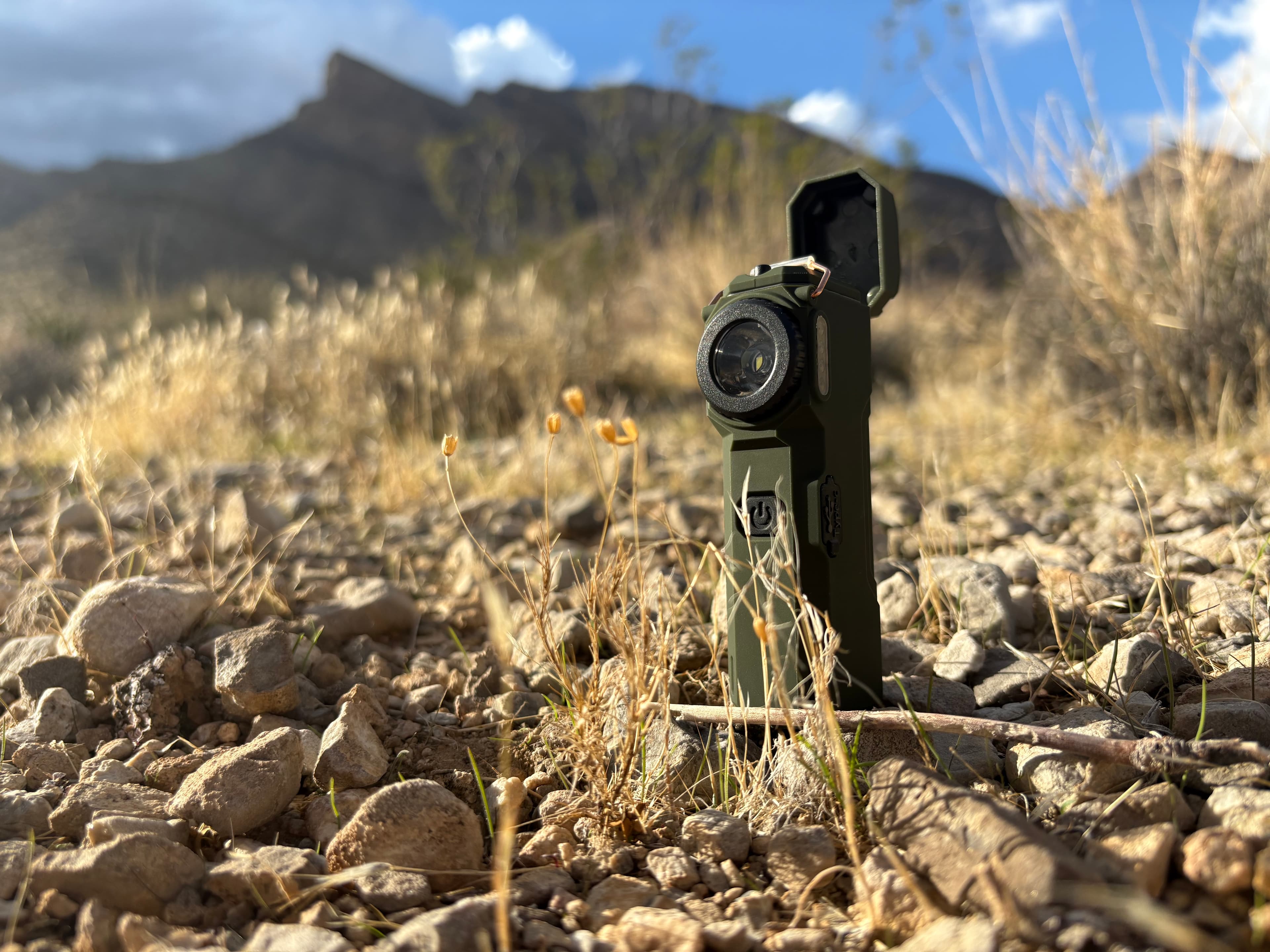 The Arc 80 standing in dry grass with mountains behind