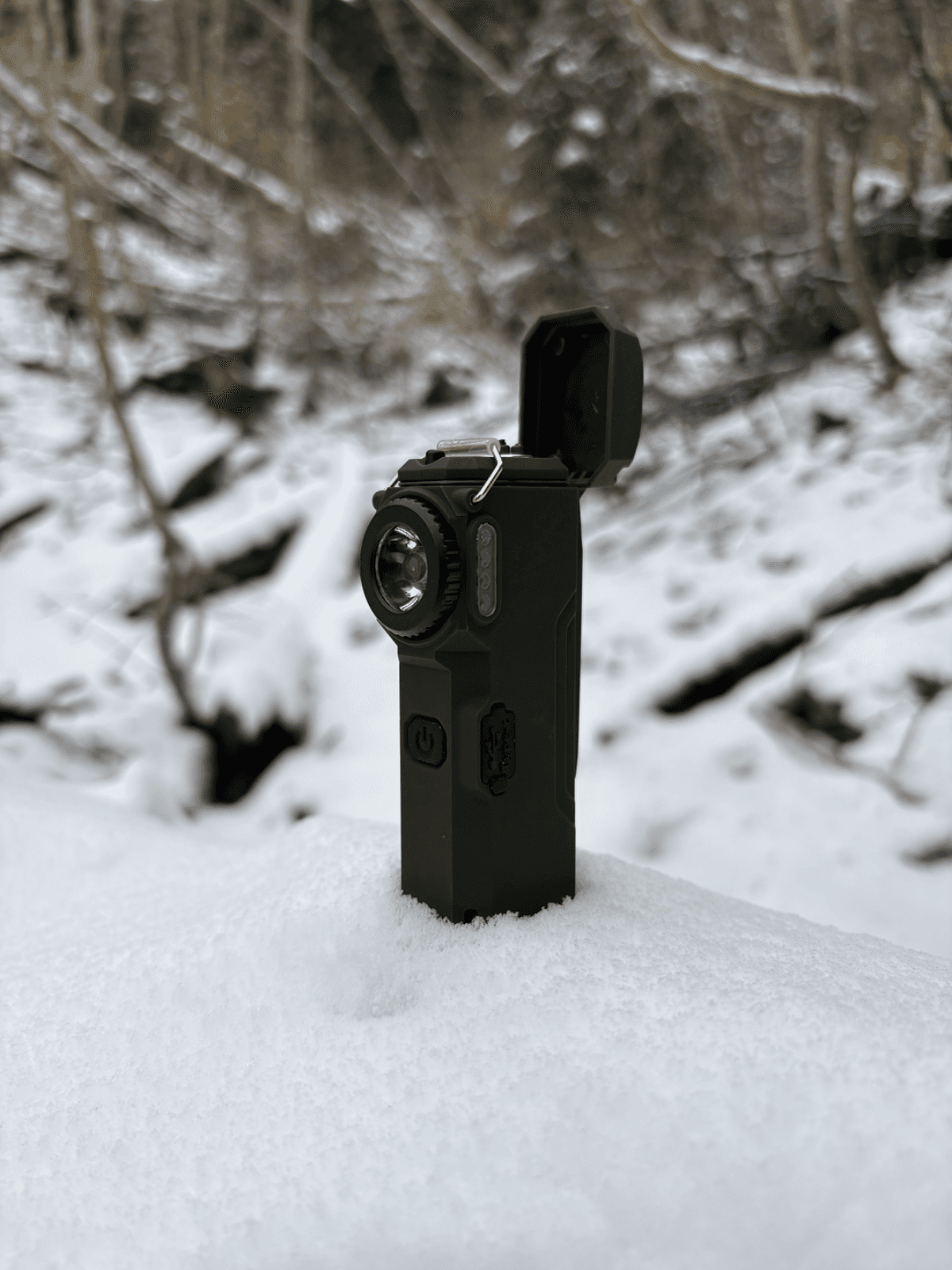 The Arc 80 standing upright in fresh snow, lid open